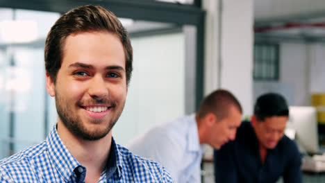 Portrait-of-business-executive-smiling-in-office