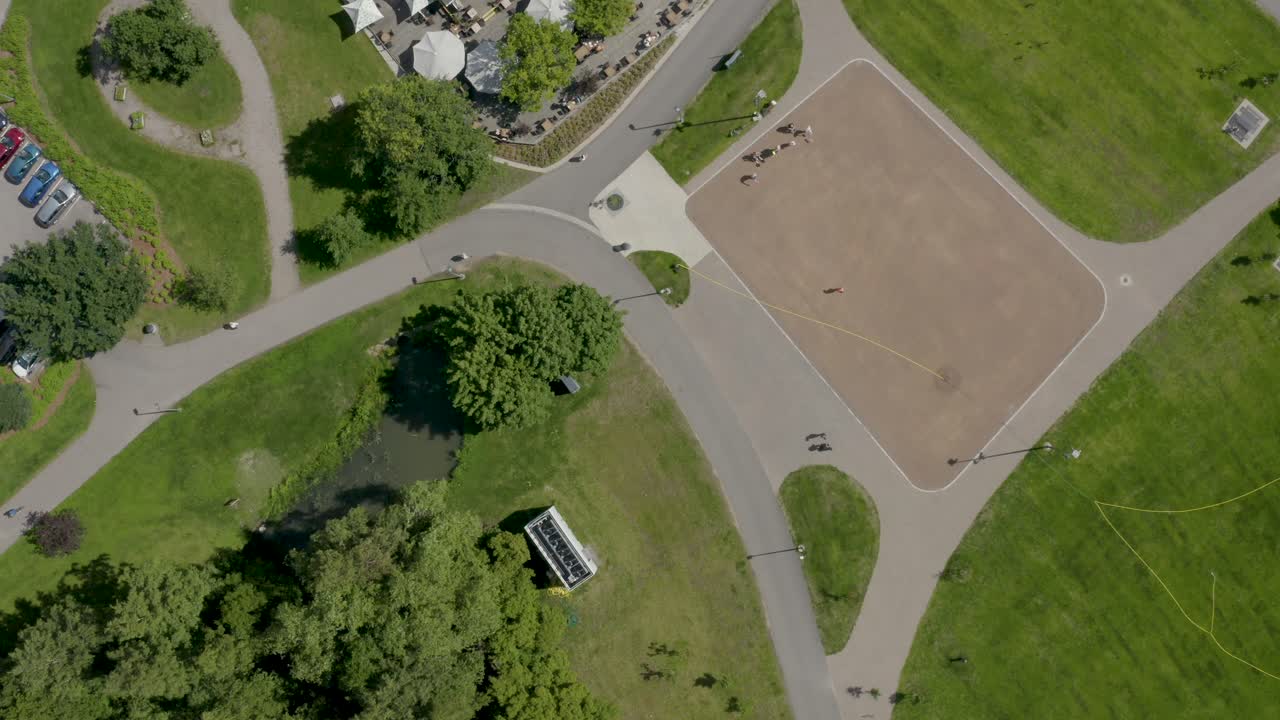 Top down aerial view of people playing on a court in a park in Finland near Helsinki