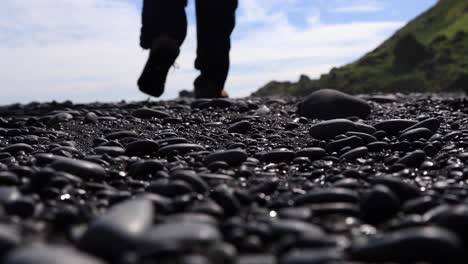 close up boots on black beach iceland