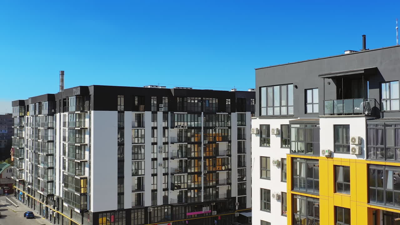 Contemporary residential building in the city. Exterior of a modern design of multistorey apartment building. Aerial view.