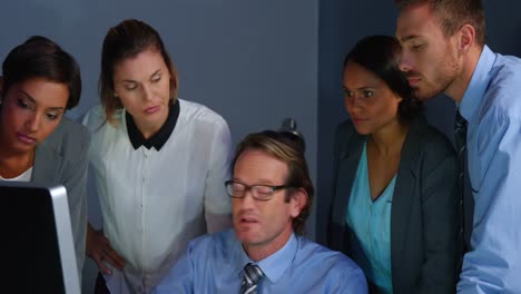 Businessman-discussing-over-computer-with-colleague-in-office