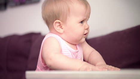 beautiful baby standing on sofa. sweet child learning to walk