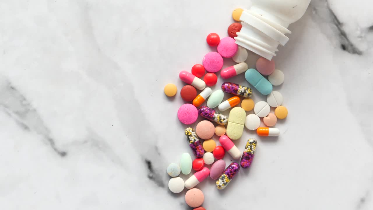 Assorted Colorful Pills and Capsules on Marble Surface