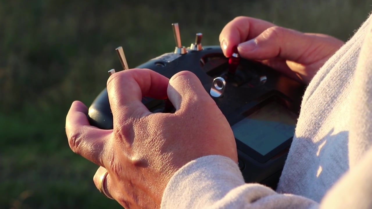 Man controlling a drone close up. Drone controller or QUAD controller handling.