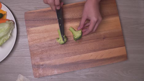 cooker sliced the broccoli in half on a cutting board - overhead shot