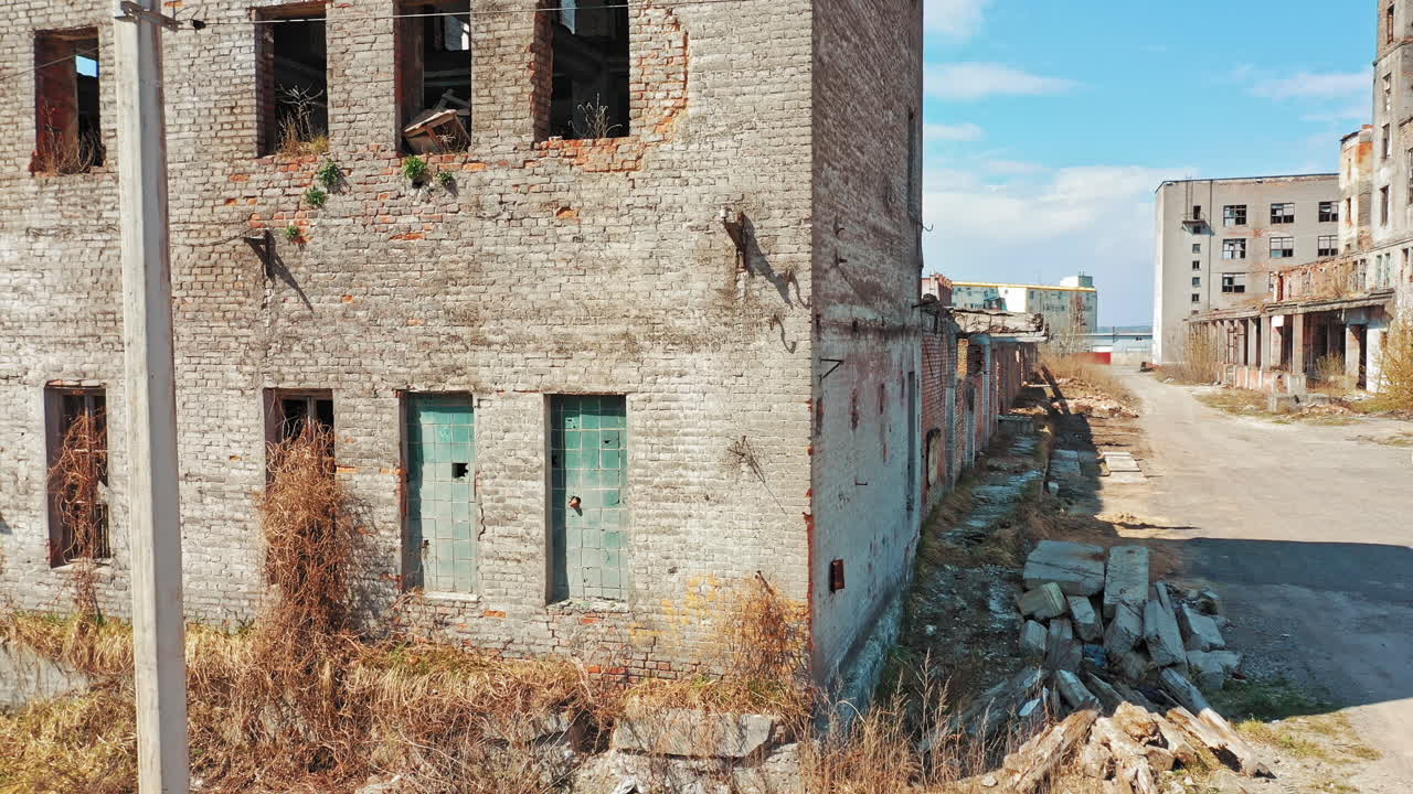 Flight over the destroyed factory. Old industrial building for demolition. Aerial view