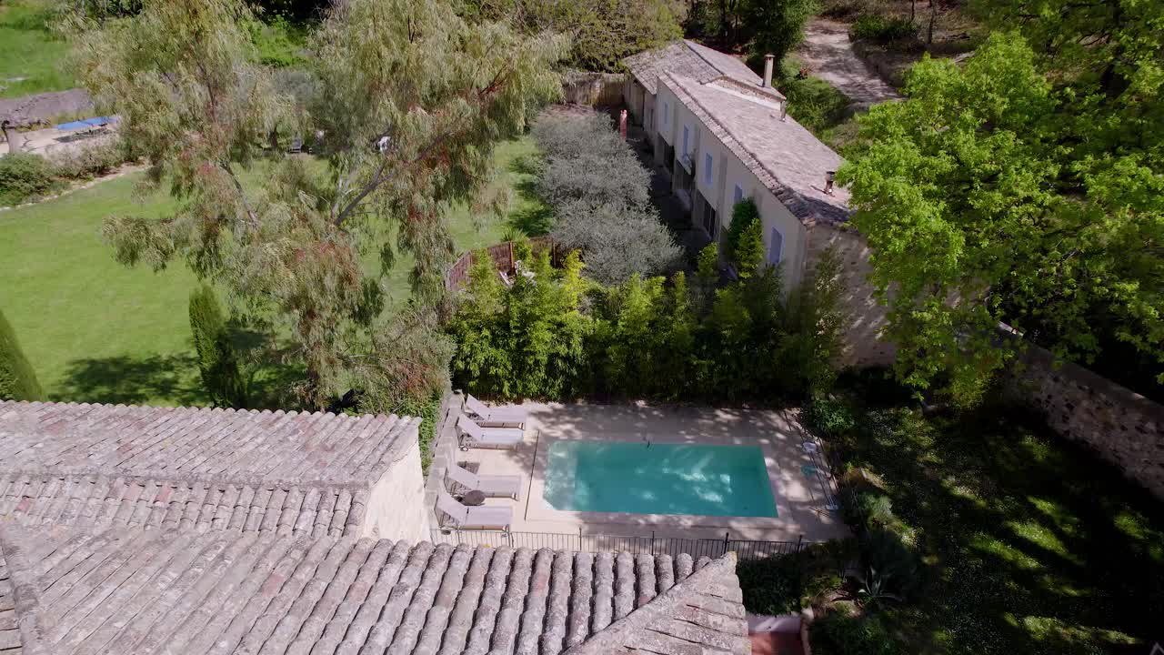 In the heart of a serene forest, a charming house stands gracefully, adorned with a sparkling pool that invites tranquil relaxation amidst nature's embrace