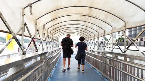 couple strolls along a covered pier