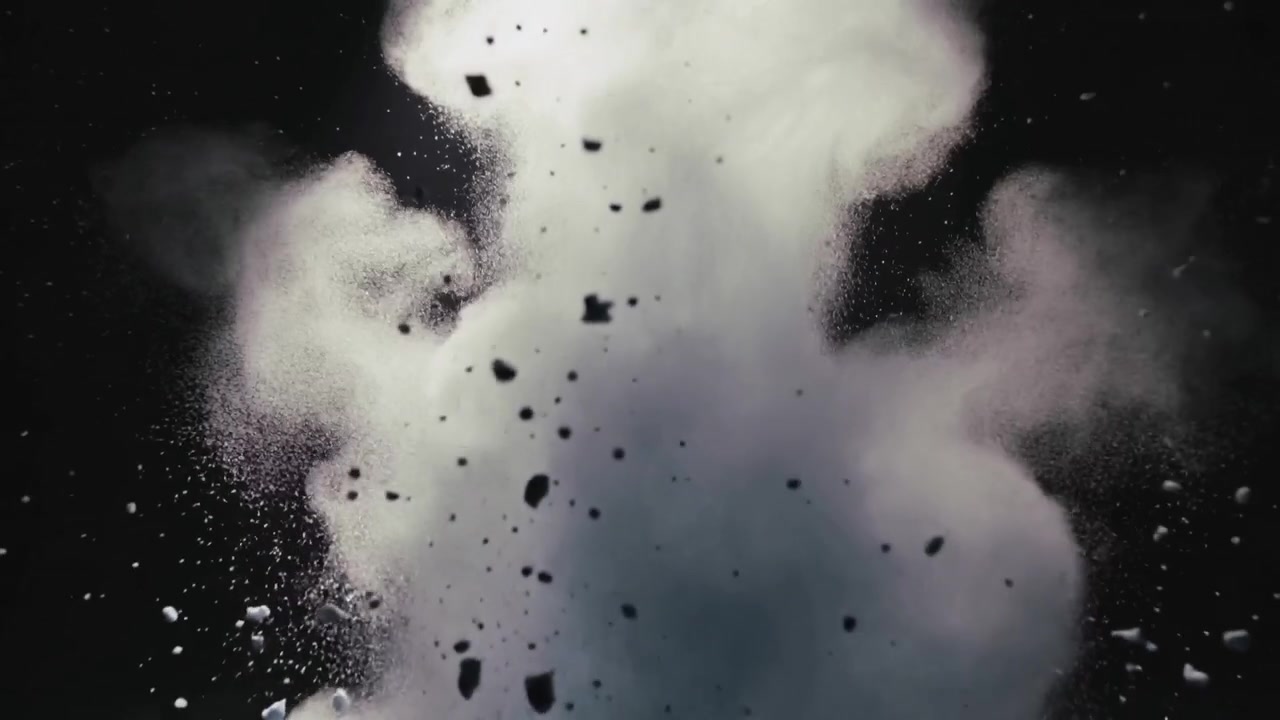 Jaillissant d'une explosion inférieure sur fond noir, un panache blanc dense projetant des débris sombres et de la poussière.