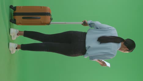 woman with luggage on green screen