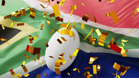 animación de confeti sobre una pelota blanca de rugby y la bandera de sudáfrica