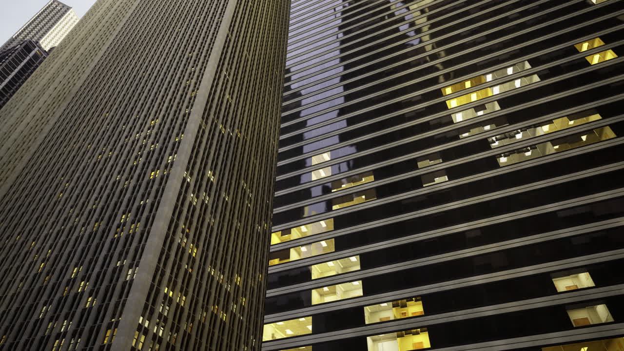 Skyscrapers illuminated at dusk reflecting urban architecture