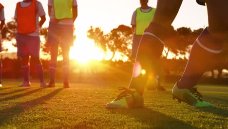 Female-soccer-players-waiting-to-kick-the-ball-on-soccer-field.-4k