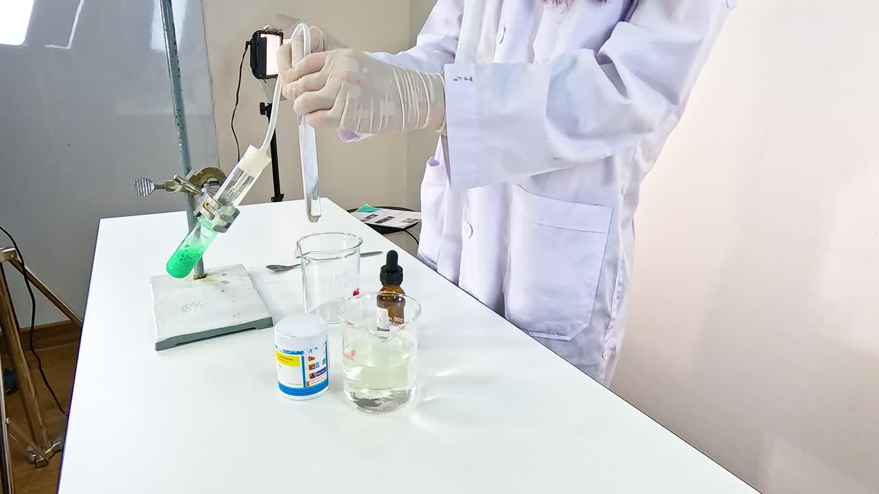Scientist conducts a chemical reaction between copper carbonate and sulfuric acid in a lab setting with controlled lighting
