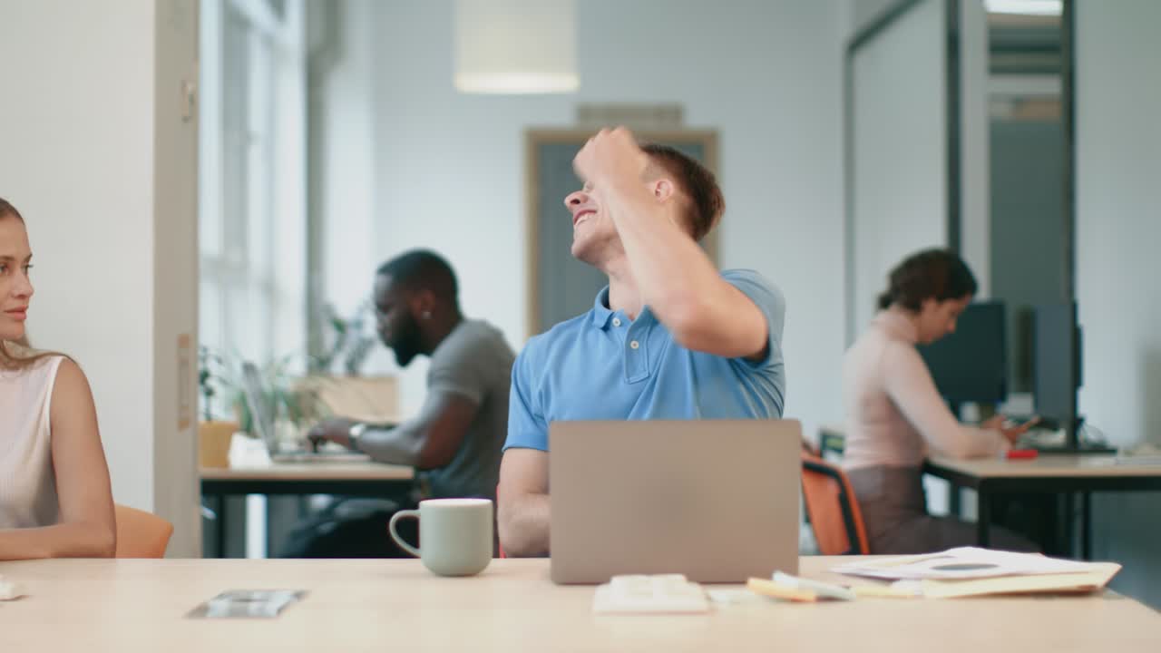 Happy business man turning round on chair at coworking space