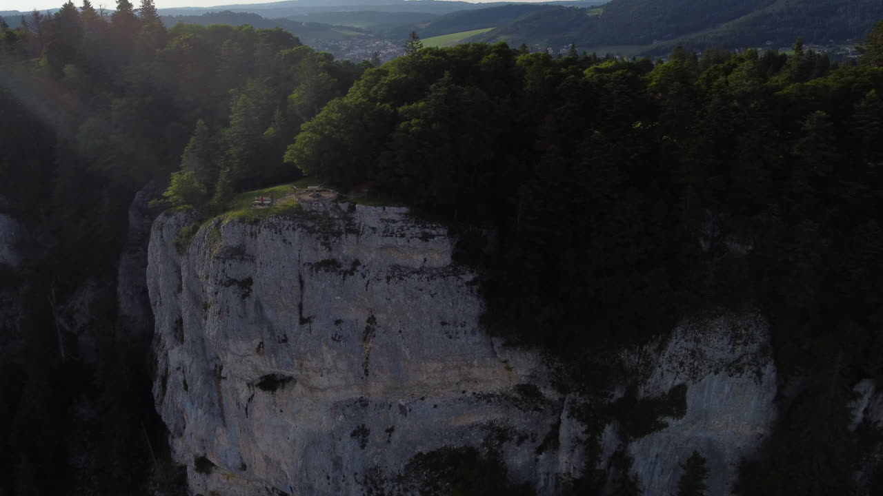 Rotating aerial shot of cliffs and the countryside of Sainte Croix, Switzerland on a sunny day.