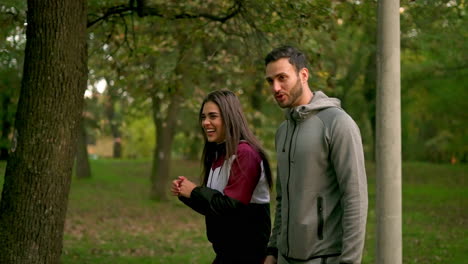 a couple walking in a park in autumn