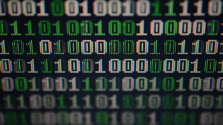 Binary code on the monitor screen. Shooting of a binary code, background