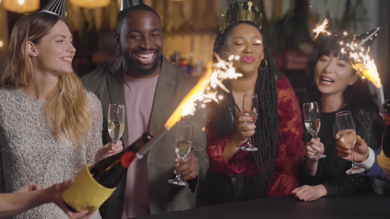 Tracking Shot Approaching Friends Celebrating New Years Eve with Sparklers and Champagne