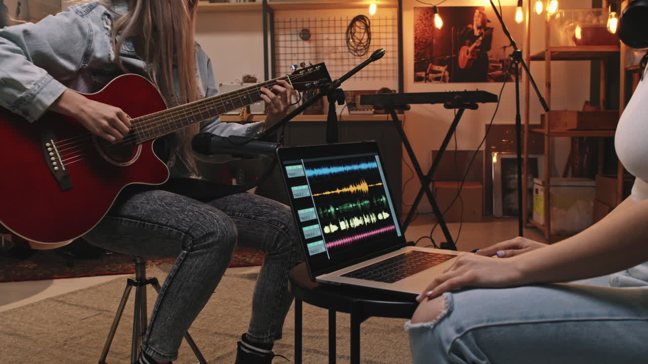 Female Guitarist Recording Music In Studio