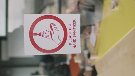 sign saying please use hand sanitizer