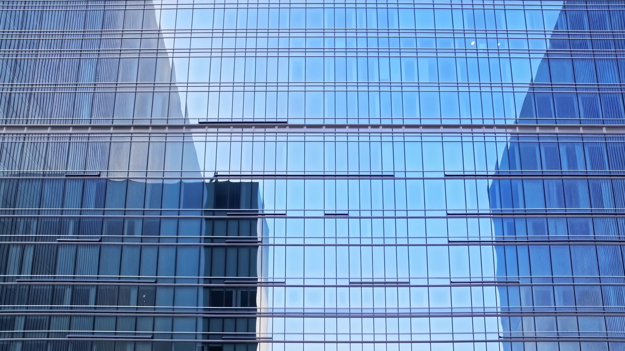 Reflective Glass Skyscraper Facade In City, Panoramic View Of Mirrored Windows And Blue Sky Reflections,