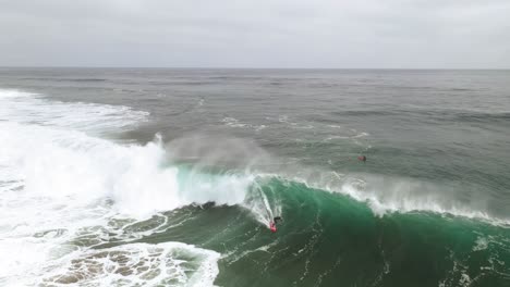 surfer riding a big wave in a lonely surf spot, feeling freedom surrounded in nature