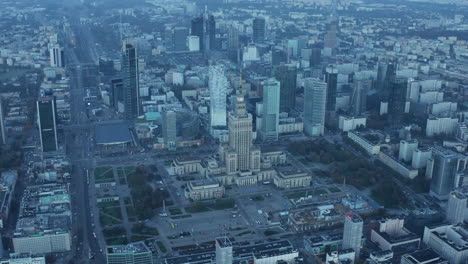 Aerial-panoramic-footage-of-morning-downtown.-Tilt-down-to-old-Soviet-style-PKIN-building.-Warsaw,-Poland