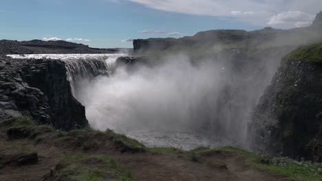 Spectacular-wide-shot-of-beautiful-Dettifoss-Waterfall-spraying-and-splashing-during-sunlight-on-Iceland-Island