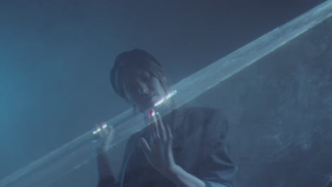 woman dancing in dark studio with laser light