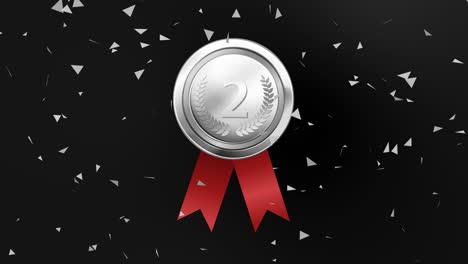 silver medal with red ribbon and confetti