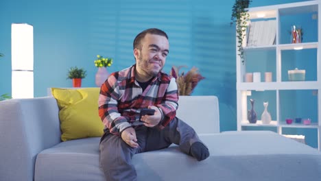 Smiling-young-disabled-man-using-smartphone-at-home.