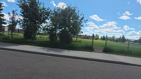 driving in a residential area in a sunny day with clouds