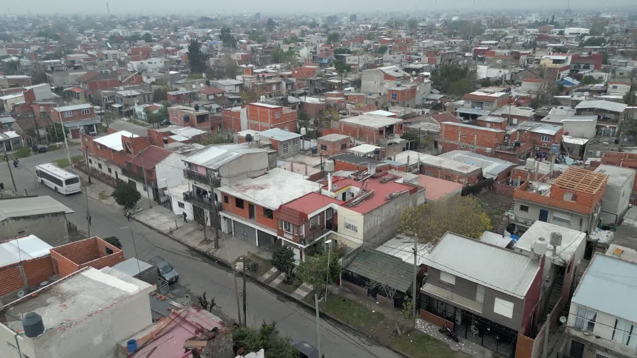 Aerial view of Villa Fiorito city, Overcrowded slums in Argentina capital under foggy sky due to climate change