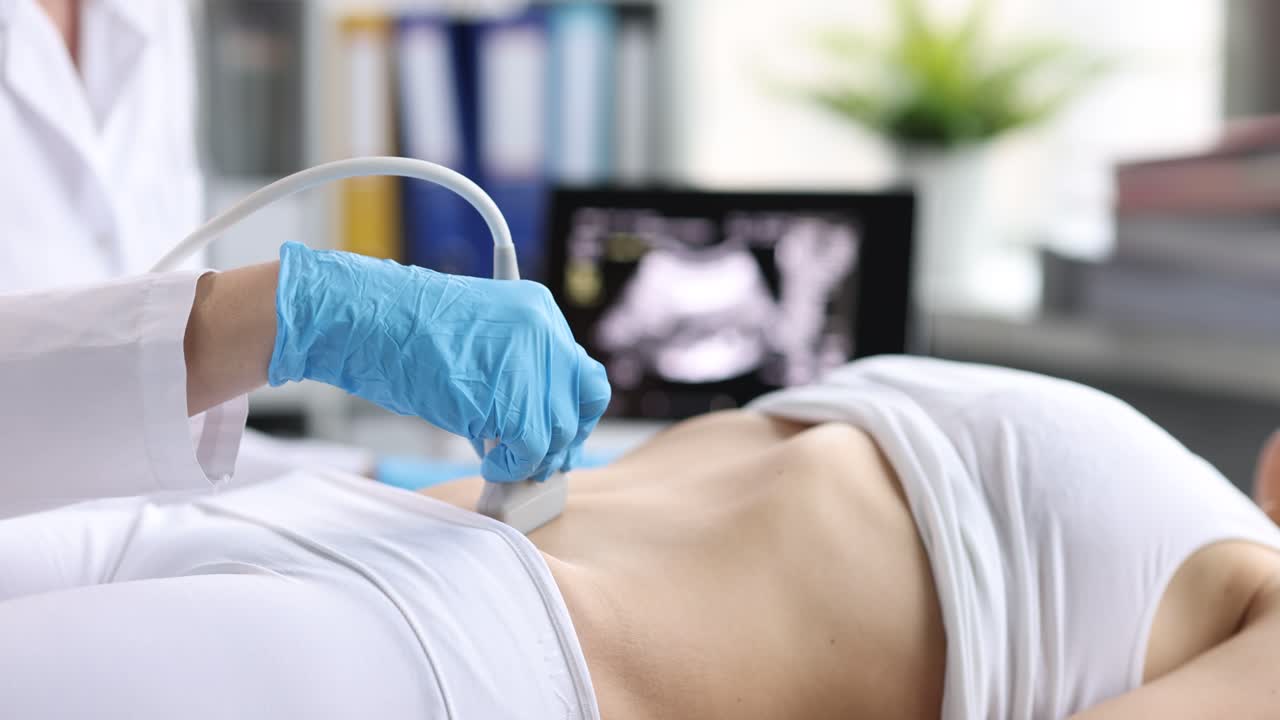 Medical professional performing an ultrasound on a patient's abdomen