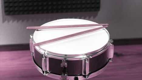 snare drum with drumsticks in a recording studio