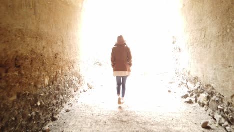 woman walking inside in ravine with big stones"