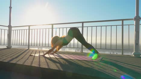 yoga practice outdoors on a bridge overlooking the river