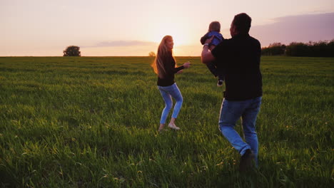 a young couple is having fun with their young child in a picturesque place