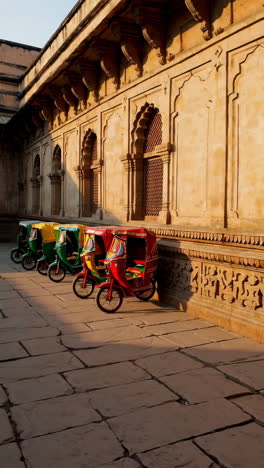 colorful rickshaws in a historic courtyard