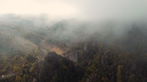 azrial view over gouffre d'enfer dam through fog and clouds near Saint Etienne, france