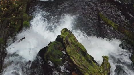 Top-down-view-of-section-of-Panther-Creek-Falls-rushing-over-rocky-ledge-into-scenic-pool,-close-up-detail