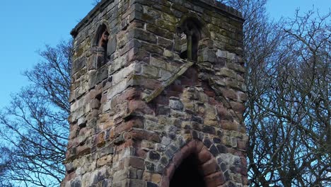 Historic-Windleshaw-Chantry-stonework-tower-exterior-slow-motion-around-ruins-with-blue-sky