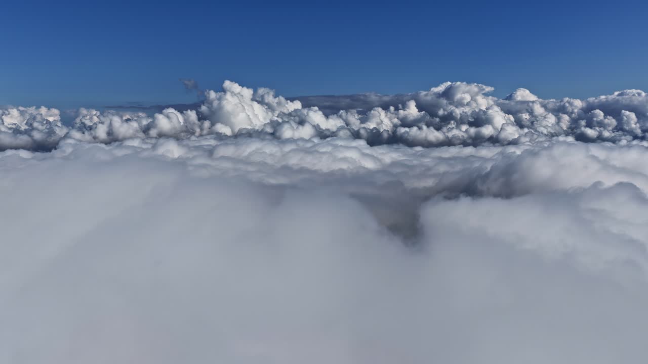 Aerial view of fluffy clouds with blue sky, serene and peaceful atmosphere