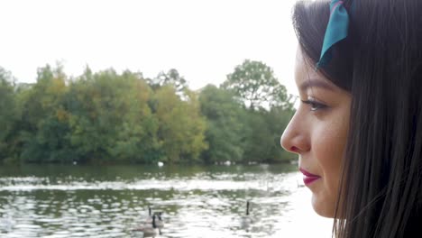 close up of woman standing by a lake