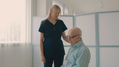 emotional sad elderly man, caring nurse cheering up