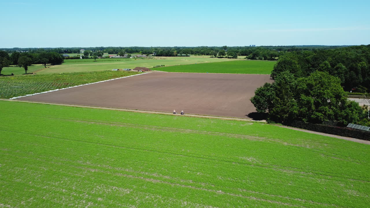 Aerial View of a Dutch Farmland with People Cycling