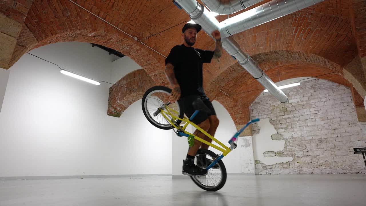 성인 남성 bmx 라이더는 자전거에서 힘든 트릭을 하고 넘어집니다.