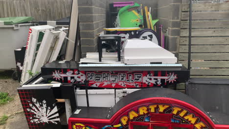 Broken-amusement-arcade-game-scrap-parts-thrown-out-in-the-trash