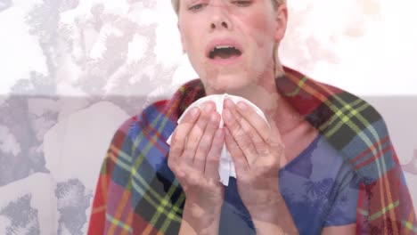 animation of ill woman wearing blanket sneezing into tissue, over macro virus